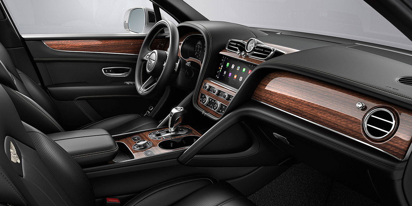 Bentley Suzhou Bentley Bentayga interior with a Crown Cut Walnut veneer, view from the passenger seat over looking the driver's seat.
