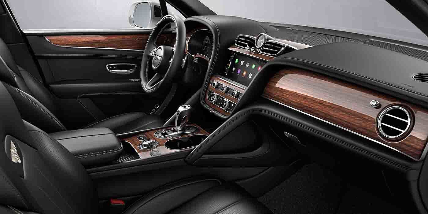 Bentley Suzhou Bentley Bentayga EWB interior with a Crown Cut Walnut veneer, view from the passenger seat over looking the driver's seat.